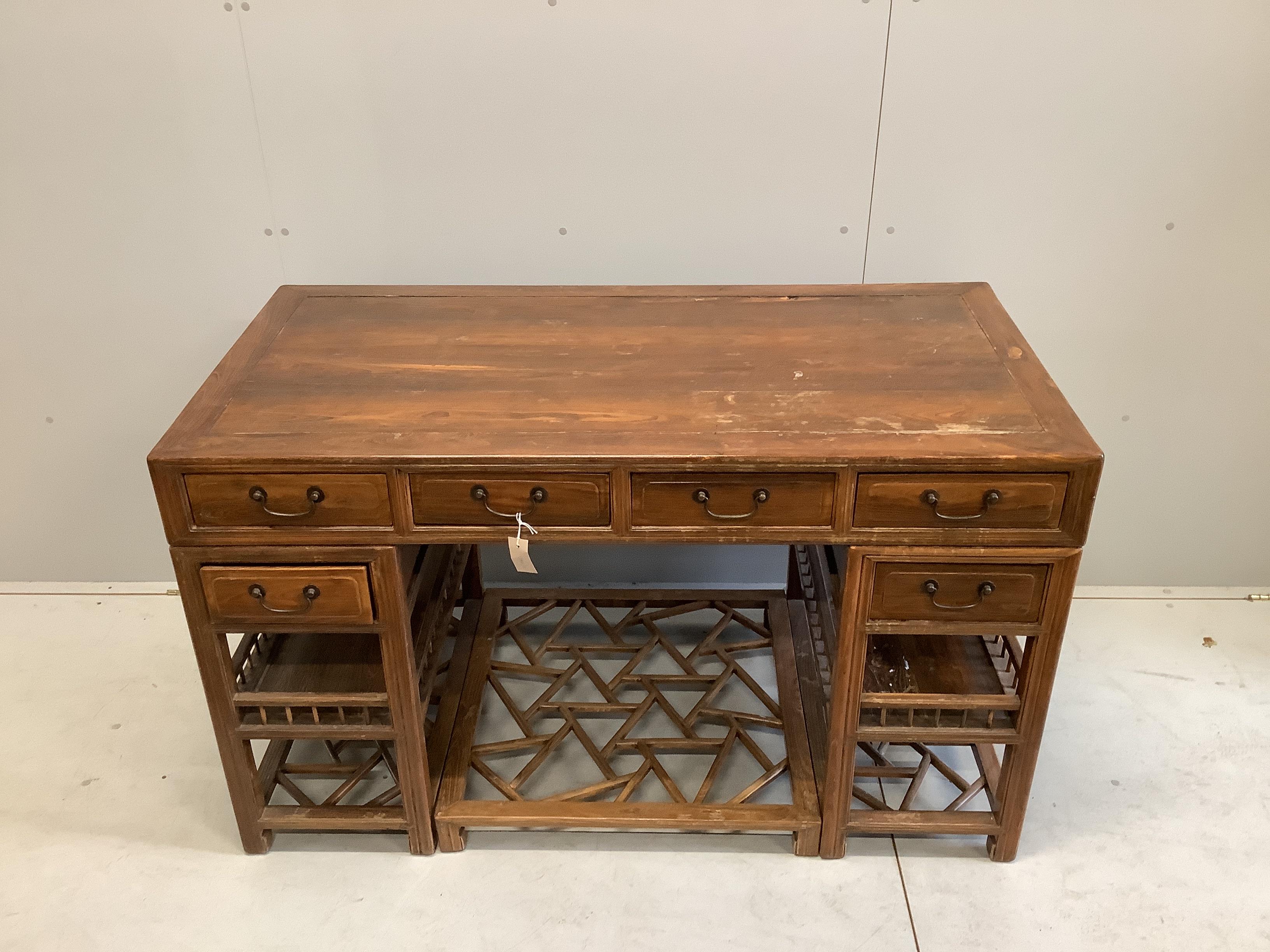 A Chinese elm pedestal desk, width 138cm, depth 68cm, height 83cm